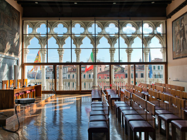 VENICE, ITALY - 17 OCTOBER 2015: Lecture hall "Aula Baratto" in Ca Foscari University, Venice, Italy with a view through tall windows over the Grand Canal and its historical palaces. 17 October 2015.